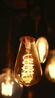 Spiral Retro light bulbs hanging on a dark background. Electricity, Vintage photo