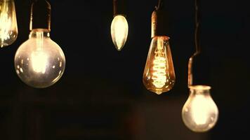 Retro light bulbs hanging on a dark background. Electricity, Vintage photo