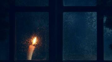 Christmas, new year, winter composition. Candle behind a frozen window photo