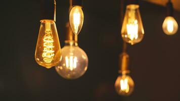 Retro light bulbs hanging on a dark background. Electricity, Vintage photo