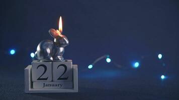 a candle burns in the form of a rabbit, a symbol of 2023 photo