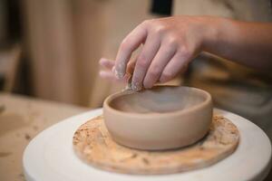 girl hands, pottery studio and painting cup in workshop for sculpture photo