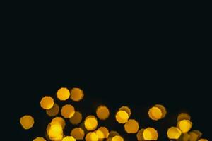 background, texture. Yellow round bokeh stars on black background photo