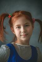 A funny cute portrait of a little girl presenting Pippi Longstocking photo