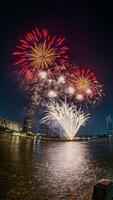 fireworks on the river in the dark sky photo