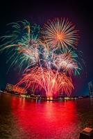 fireworks on the river in the dark sky photo