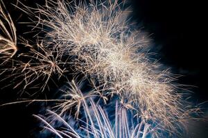 fireworks on the river in the dark sky photo