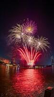 fireworks on the river in the dark sky photo