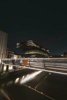 Modern City library De Krook building lit up with yellow and white lights during midnight in the centre of Ghent, Belgium. Flanders region photo