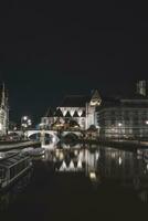 Medieval buildings on Graslei Street in the centre of Ghent by the River Leie during the night. Belgium's most famous historical centre. Ghent waterfront during midnight photo