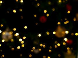 abstract christmas tree bokeh blur light orange and yellow glowing flare pattern black background photo