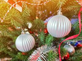 Happy new year cozy home interior with christmas tree and garlands small silver balls. blurred lights golden bokeh.Merry Christmas background. photo