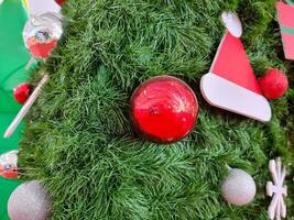 Happy new year cozy home interior with christmas tree and garlands small red balls and hat. blurred lights golden bokeh.Merry Christmas background. photo