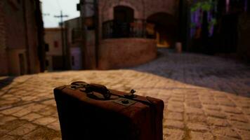 A suitcase sitting on a cobblestone street video