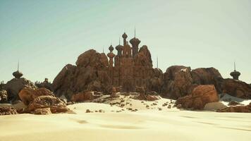 A desert scene with rocks and a building video