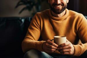 AI generated a man in a mustard sweater smiles and holds a cup of coffee or tea at home photo