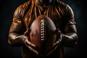 AI generated Tanned hands of an athlete holding a brown American football ball on a dark background photo