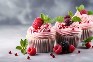 AI generated sweet cupcakes with pink cream, strawberries and raspberries on grey concrete background photo