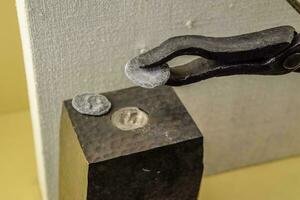Tools for minting coins. Anvil and vice, photo