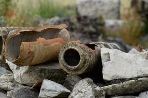 remains of ancient ceramic pipes from the water supply. Prefabricated sections of ceramics from which the pipeline was assembled. photo