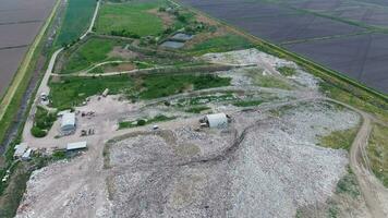 garbage dump with heaps of garbage and treatment facilities. Landfill of garbage outside the village photo
