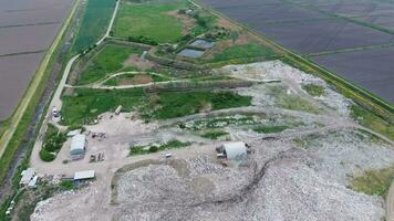 garbage dump with heaps of garbage and treatment facilities. Landfill of garbage outside the village photo