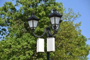 The loudspeaker on the pole. Outdoor speakers for fun walking in the park. A pillar with lights and speakers. photo