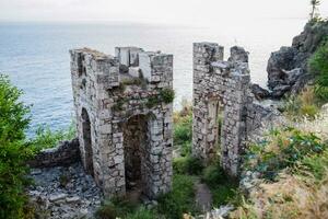 Ruins of ancient buildings on coast of Antalya. Ancient buildings by the sea. photo