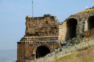 Ancient antique amphitheater in city of Hierapolis in Turkey. Side view. Steps and antique statues with columns in the amphitheater photo