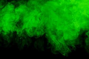 Green cloud of smoke on black background photo