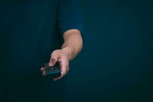 Concepts of using digital media, social media Surfing online, male hand using remote control To play or use social media, the concept of working remotely, working from home via the internet. photo