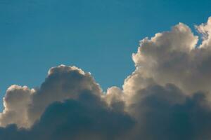 various shapes of clouds on different levels of blue background photo