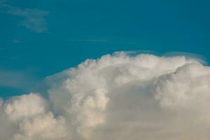 various shapes of clouds on different levels of blue background photo