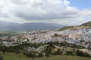 A picture from above the blue city of Chefchaouen with clouds photo