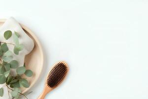 AI generated Wooden hair brush with tray and towel on white background, copy space background for your design photo