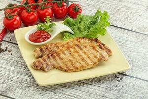 Grilled pork steak with ketchup photo