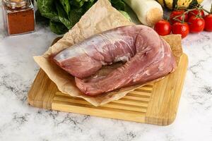 Uncooked raw pork tenderloin with spices photo