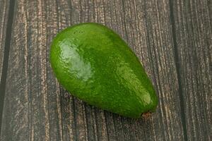 Ripe green avocado over background photo