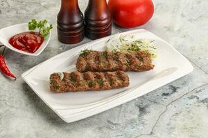 Kebab with beef served onion photo