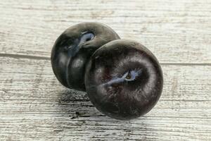 Two ripe sweet black plums photo