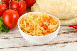 Fermented cabbage sauerkraut in the bowl photo