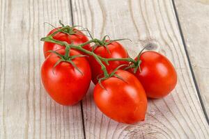 Raw red Flamenco tomato branch photo