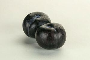 Two ripe sweet black plums photo