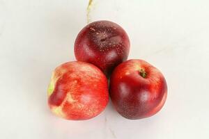 Ripe sweet juicy nectarines heap photo