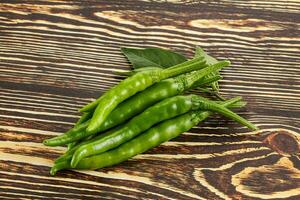 Spicy green chili pepper heap photo
