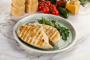 Grilled chicken breast served arugula photo