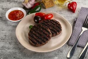 Grilled burger cutlet with sauce photo