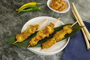 Thai meat skewer Satay with sauce photo