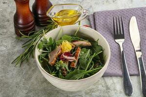 Salad with roasted duck and orange photo