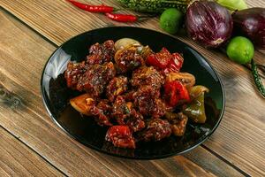 Asian cuisine - pork with chili sauce photo